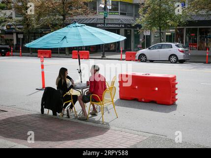 200615 -- VANCOUVER, 15. Juni 2020 Xinhua -- Bewohner essen auf einer Terrasse am Straßenrand in North Vancouver, British Columbia, Kanada, 14. Juni 2020. Die Kommunalverwaltungen in Metro Vancouver nutzen Straßen in der Region um, indem sie die Fahrspuren auf offene Terrassen am Straßenrand reduzieren, was Fußgängern sicherere Bewegungsfreiheit und räumliche Distanzierung bietet und Unternehmen bei den schwierigen wirtschaftlichen Herausforderungen unterstützt. Foto von Liang Sen/Xinhua CANADA-VANCOUVER-COVID-19-ROADSIDE PATIOS PUBLICATIONxNOTxINxCHN Stockfoto