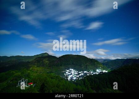 200825 -- FUZHOU, 25. August 2020 -- Foto aufgenommen am 1. August 2020 zeigt einen nächtlichen Blick auf das Dorf Chenqiao, Zhouning County, südöstliche Provinz Fujian. Chenqiao ist ein tausendjähriges Dorf in der Provinz Fujian, das für seine Täler, Wasserfälle und das Wolkenmeer berühmt ist und von hohen Bergen umgeben ist. Mit einer Höhe von 936 Metern und einer durchschnittlichen Temperatur von 24 Grad Celsius im Sommer ist es auch ein beliebtes Sommerresort für Touristen. Seit Beginn des Sommers zieht es immer mehr Besucher zum Wandern, Campen und Sightseeing an. Stockfoto