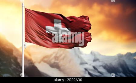 Flagge der Schweiz auf einem Fahnenmast vor einem bunten Himmel Stockfoto