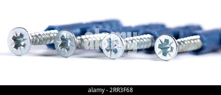 Chrome screws on white background. Self-tapping screws from steel close-up Stockfoto