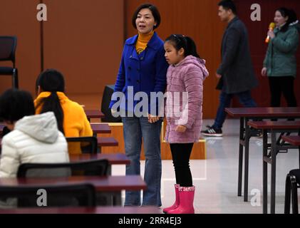 201202 -- WUHU, 2. Dezember 2020 -- Xi Weijing, Leiterin der Schule für Blinde in Wuhu, führt eine Schülerin während der Musikprobe an der Schule in Wuhu, ostchinesische Provinz Anhui, am 25. November 2020 zu ihrem Platz. XI Weijings Eltern sind beide sehbehindert. Ihr Vater Xi Manqiao gründete 1979 eine private Schule für Blinde und widmete all seine Energie der Arbeit der Schule. Nachdem ihr Vater 1994 an Krankheit gestorben war, übernahm Xi Weijing, damals in ihren 20ern, die Last und wurde der zweite Direktor der Wuhu Schule für Blinde. Mit Unterstützung der örtlichen Regierung, der Wuhu Schule für Blinde Stockfoto