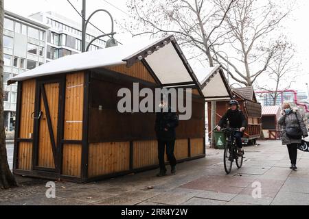 201216 -- BERLIN, 16. Dezember 2020 -- Fußgänger gehen an geschlossenen Weihnachtshütten in Berlin, Hauptstadt Deutschlands, 16. Dezember 2020 vorbei. Deutschland wird ab Mittwoch in eine strengere Sperrung verfallen, nicht unbedingt notwendige Geschäfte schließen und die Größe privater Treffen begrenzen, wie Bundeskanzlerin Angela Merkel und die Staats- und Regierungschefs der Region am Sonntag vereinbart haben. Die strengeren restriktiven Maßnahmen, die bis zum 10. Januar in Kraft sein werden, waren nach einem Strategiepapier eine Reaktion auf einen exponentiellen Anstieg der Zahl der COVID-19-Fälle in Deutschland. ShanYuqi GERMANY-BERLIN-COVID-19-LOCKDOWN ShanxYuqi PUBLICATIONxNOTxINxCHN Stockfoto