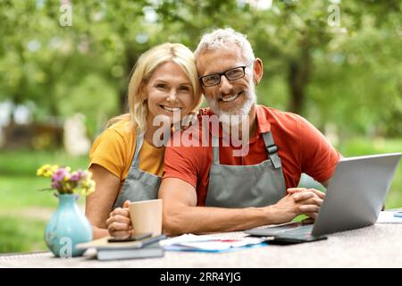 Happy Mature Ehepaar Mit Laptop Und Tee Entspannend Im Garten Stockfoto