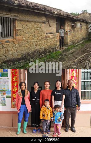 201222 -- HAIKOU, 22. Dez. 2020 -- NACH OBEN: Foto aus dem Jahr 2016 zeigt den Dorfbewohner Chen Lixiang, der mit seinem alten Haus im Dorf Baorui im Kreis Qiongzhong in der südchinesischen Provinz Hainan posiert. UNTEN: Foto aufgenommen am 17. Dezember 2020 von zeigt die Dorfbewohnerin Chen Lixiang 1st L und ihre Familienmitglieder, die mit ihrem neuen Zuhause im Dorf Baorui posieren. Besucher werden wahrscheinlich von brandneuen Wohnhäusern und glatten asphaltierten Straßen beeindruckt sein, wenn sie das Dorf Baorui in der Provinz Hainan besuchen. Aber eine solche Szene ist kaum vorstellbar im Jahr 2017, als die Menschen der Li-ethnischen Gruppe, die hier lebten, größtenteils in Armut und liv verstrickt waren Stockfoto