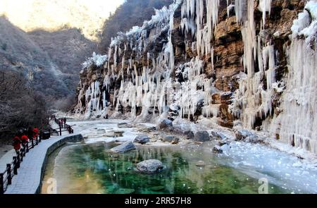 201225 -- PEKING, 25. Dezember 2020 -- Luftaufnahme aufgenommen am 24. Dezember 2020 zeigt Menschen die Landschaft der gefrorenen Wasserfälle am Yuntai Mountain Scenic Spot in Jiaozuo, der zentralchinesischen Provinz Henan. XINHUA FOTOS DES TAGES HaoxYuan PUBLICATIONxNOTxINxCHN Stockfoto