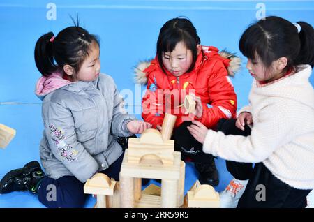 201229 -- BIJIE, 29. Dezember 2020 -- Li Qingyi C spielt in einem Kindergarten im Dafang County, Südwestchinas Provinz Guizhou, 24. Dezember 2020. Li Siyu, 8, und seine 6-jährige Schwester Li Qingyi, lebten früher im Dorf Hetou als Mitglieder eines armutsgeplagten Haushalts. Sie mussten jeden Tag fast eine Stunde zur Schule laufen. Ihre Eltern arbeiteten in anderen Städten, und Li Changde, der 68-jährige Großvater, übernahm die Verantwortung, sie zur Schule und von dort zu bringen. Im Jahr 2019 zog die ganze Familie von Li Changde im Rahmen des Umsiedlungsprojekts zur Armutsbekämpfung in ein neues Wohnhaus Stockfoto