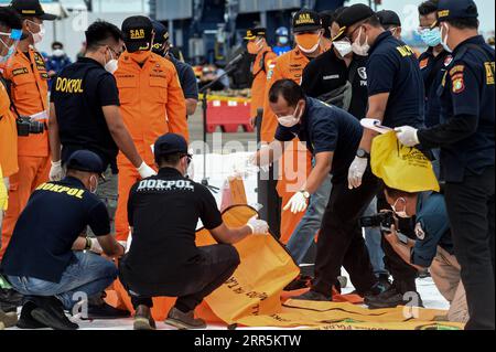 News Bilder des Tages 210110 -- JAKARTA, 10. Januar 2021 -- Mitglieder des indonesischen Search and Rescue SAR Teams überprüfen Körperteile von Passagieren an Bord des Sriwijaya Air Fluges SJ-182 in Tanjung Priok Port, Jakarta, Indonesien, 10. Januar 2021. Die Rettungskräfte sammelten am Sonntag fünf Säcke mit menschlichen Körperteilen und drei Säcke mit Trümmern des Flugzeugs Sriwijaya, das in den Gewässern vor der Küste der indonesischen Hauptstadt Jakarta abstürzte, sagte ein hochrangiger Beamter. Foto von /Xinhua INDONESIA-JAKARTA-FLUGZEUGABSTURZ-SUCHE AgungxKuncahyaxB. PUBLICATIONxNOTxINxCHN Stockfoto