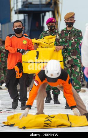 210111 -- JAKARTA, 11. Januar 2021 -- indonesische Such- und Rettungsoffiziere tragen Taschen mit Körperteilen der Opfer des Flugzeugabsturzes Sriwijaya im SAR-Kommandozentrum Tanjung Priok, Jakarta, Indonesien, am 11. Januar, 2021. das Such- und Rettungsteam Indonesiens hat das Einsatzgebiet erweitert, um nach Trümmern und Opfern des Flugzeugabsturzes Sriwijaya mit mehr Flotten am dritten Einsatztag zu suchen, teilte die indonesische nationale Such- und Rettungsagentur am Montag mit. Bis jetzt haben die Offiziere die Trümmer des unglückseligen Flugzeugs und Leichenteile, die Eigentum der Opfer sind, gefunden Stockfoto