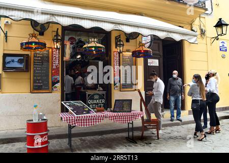 210115 -- HAVANNA, 15. Januar 2021 -- Menschen mit Gesichtsmasken warten vor einem Restaurant in Havanna, Kuba, 14. Januar 2021. Die Kommunalregierung in Havanna kündigte als Reaktion auf die COVID-19-Pandemie neue restriktive Maßnahmen an, da am Mittwoch landesweit 550 neue Fälle gemeldet wurden, was am sechsten Tag in Folge einen neuen Tagesrekord darstellt. Foto von /Xinhua CUBA-HAVANA-COVID-19-FÄLLE JoaquinxHernandez PUBLICATIONxNOTxINxCHN Stockfoto