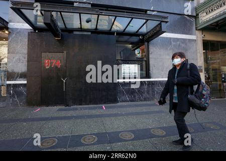 210123 -- VANCOUVER, 23. Januar 2021 -- Ein Bewohner, Der eine Gesichtsmaske trägt, geht an einem geschlossenen Geschäft in Vancouver, Kanada, vorbei, 22. Januar 2021. Foto: /Xinhua CANADA-VANCOUVER-COIVD-19 LiangxSen PUBLICATIONxNOTxINxCHN Stockfoto