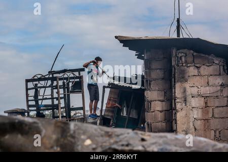 210221 -- MANILA, 21. Februar 2021 -- Ein Bewohner sucht nach seinem Eigentum in seinem verkohlten Haus nach einem Brand in einem Slum-Gebiet in Manila, Philippinen am 21. Februar 2021. Fünf Menschen starben, als ein sechsstündiger Brand rund 300 Häuser im Tondo-Viertel von Manila auf den Philippinen zerstörte, sagte ein Feuerwehrmann am Sonntag. PHILIPPINEN-MANILA-FIRE RouellexUmali PUBLICATIONxNOTxINxCHN Stockfoto