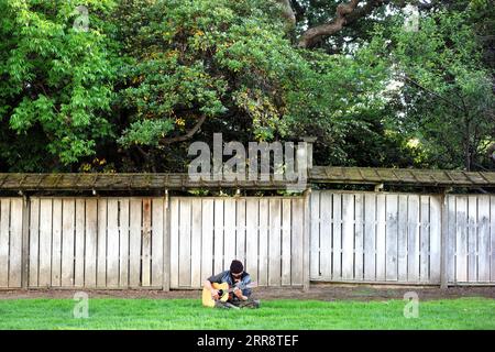 210518 -- SAN MATEO, 18. Mai 2021 -- Ein Mann mit Maske spielt Gitarre in einem Park in San Mateo, Kalifornien, USA, 17. Mai 2021. Kalifornische Gesundheitsbeamte sagten Montag, der bevölkerungsreichste Staat der Vereinigten Staaten würde die CDC-Richtlinien nicht umsetzen, die es vollständig geimpften Menschen erlauben, in den meisten Situationen vor dem 15. Juni ohne Maske zu gehen. Letzte Woche sagte das US-Zentrum für Krankheitskontrolle und Prävention CDC, dass es für vollständig geimpfte Menschen sicher ist, Gesichtsbedeckungen und soziale Distanzierung in den meisten Situationen zu überspringen, und viele staaten haben ihre Maskenanforderungen angehoben. Jedoch Stockfoto