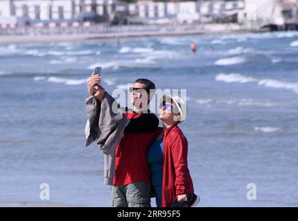 210528 -- CAGLIARI ITALIEN, 28. Mai 2021 -- Menschen machen am 28. Mai 2021 ein Selfie an einem Strand in Cagliari, Sardinien, Italien. Alle italienischen Regionen sind seit Montag gelb geworden, was ein geringes Ansteckungsrisiko und das niedrigste Maß an Anti-COVID-19-Einschränkungen anzeigt, so die nationalen Gesundheitsbehörden des Landes. Foto von /Xinhua ITALY-SARDINIA-CAGLIARI-COVID-19-RESTRICTIONS-EASE AlbertoxLingria PUBLICATIONxNOTxINxCHN Stockfoto