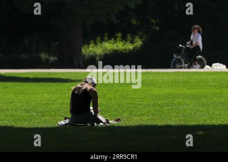 210609 -- BRÜSSEL, 9. Juni 2021 -- Eine Frau sitzt am 9. Juni 2021 im Park des fünfzigsten Jahrestages in Brüssel, Belgien. Der Sommerplan Belgiens ist am Mittwoch in Kraft getreten. Das Gastgewerbe darf von 5.00 Uhr bis 23.30 Uhr wieder Innenbereiche öffnen. Der Beratende Ausschuss in Belgien hat am 4. Juni neue Reiseregeln und Entspannungspläne vereinbart, um den Menschen die sichere Reise für ihren Sommerurlaub zu ermöglichen. BELGIEN-BRÜSSEL-COVID-19-SOMMERPLAN ZhengxHuansong PUBLICATIONxNOTxINxCHN Stockfoto