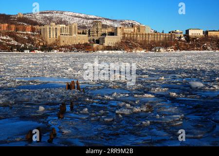 Die United States Military Academy (USMA) befindet sich an einem kalten Wintertag über einem gefrorenen und eisigen Hudson River Stockfoto