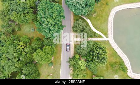 210714 -- SHENYANG, 14. Juli 2021 -- Luftaufnahme zeigt ein selbstfahrendes Fahrzeug, das von Neusoft REACH Automobile Technology Co., Ltd. Während eines Tests auf geschlossenen Straßen in Shenyang, nordöstliche chinesische Provinz Liaoning, am 9. Juli 2021 entwickelt wurde. Das Unternehmen hat kürzlich seine selbstfahrenden Fahrzeuge der Stufe 4 sowohl auf geschlossenen als auch auf offenen Straßen getestet. CHINA-LIAONING-SHENYANG-SELBSTFAHRENDE FAHRZEUGE CN YANGXQING PUBLICATIONXNOTXINXCHN Stockfoto