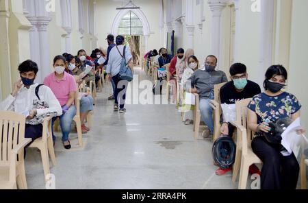 210715 -- BANGALORE, 15. Juli 2021 -- Menschen, die zur Arbeit oder Ausbildung ins Ausland reisen sollen, warten darauf, sich anzumelden, bevor sie die zweite Dosis Covishield-Impfstoff am 15. Juli 2021 in den Räumlichkeiten eines Colleges in Bangalore, Indien, erhalten. STR/Xinhua INDIA-BANGALORE-COVID-19-VACCINATION Stringer PUBLICATIONxNOTxINxCHN Stockfoto