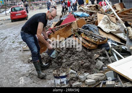 210716 -- VERVIERS BELGIEN, 16. Juli 2021 -- Ein Mann reinigt den Schlamm nach Überschwemmungen in Verviers, Belgien, 16. Juli 2021. Belgien hat den 20. Juli zu einem nationalen Tag der Trauer über die Opfer des Unwetters der letzten Tage erklärt. 21 Menschen starben und 18 wurden am Freitag nach Sturzfluten vermisst, bei denen Flüsse ihre Ufer im Süden und Osten des Landes platzen sahen. BELGIEN-VERVIERS-FLOOD-AFTERMATH ZhangxCheng PUBLICATIONxNOTxINxCHN Stockfoto