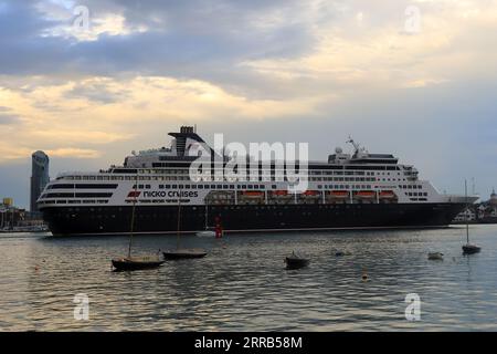 Ein Kreuzfahrtschiff, das am Ufer von Southsea vorbeifährt, während sie den Hafen von Portsmouth verlässt. Vasco da Gama ist ein Kreuzfahrtschiff der S-Klasse, das von Mystic Invest und Nicko Cruises betrieben wird. Frühere Namen sind Statendam und Pacific Eden. Sie ist derzeit im portugiesischen Hafen Madeira registriert und nach dem portugiesischen Entdecker benannt. Das Schiff verfügt über 14 Decks und kann 1258 Passagiere und 557 Besatzungen befördern. Stockfoto