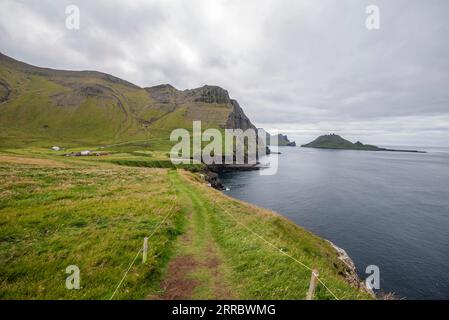 Blick auf die Insel Tindholmur mit dem Drachen von einem Wanderweg über dem Dorf Gasadalur am Nordwestrand der Insel Vagar auf den Färöern Stockfoto