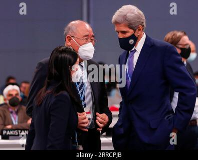 211114 -- GLASGOW, 14. November 2021 -- Xie Zhenhua C, chinesischer Sondergesandter für den Klimawandel, spricht mit John Kerry R, US-Sondergesandter des Präsidenten für den Klimaschutz, während der 26. Tagung der Konferenz der Vertragsparteien COP26 des Rahmenübereinkommens der Vereinten Nationen über Klimaänderungen in Glasgow, Vereinigtes Königreich, 13. November 2021. Die Klimakonferenz der Vereinten Nationen endete hier am Samstag nach einer eintägigen Verlängerung, wobei die Verhandlungsführer sich auf einen neuen globalen Pakt zur Bekämpfung des Klimawandels einigten. UK-GLASGOW-COP26-FAZIT HanxYan PUBLICATIONxNOTxINxCHN Stockfoto