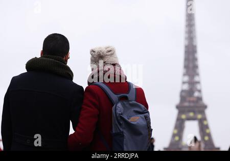 211230 -- PARIS, 30. Dezember 2021 -- die Leute schauen auf den Eiffelturm am Trocadero Place in Paris, Frankreich, 29. Dezember 2021. Frankreich meldete am Mittwoch 208.099 neue bestätigte COVID-19-Fälle, die in den letzten 24 Stunden entdeckt wurden, ein neuer Tagesrekord seit dem Ausbruch der Pandemie in Frankreich. FRANKREICH-COVID-19-FÄLLE GaoxJing PUBLICATIONxNOTxINxCHN Stockfoto