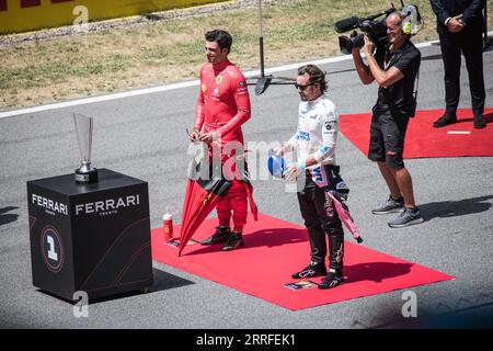 Beim Großen Preis von Spanien stehen die F1-Fahrer Carlos Sainz und Fernando Alonso bei einem Vorlauf nebeneinander. Stockfoto