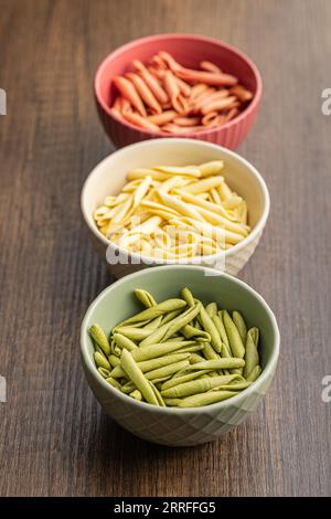 Fusilli pugliesi. Italienische dreifarbige gedrehte Pasta in der Schüssel. Stockfoto