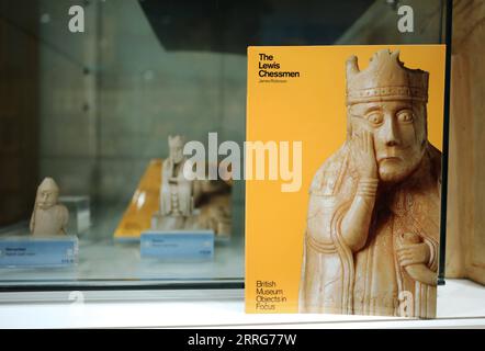 220512 -- LONDON, 12. Mai 2022 -- Foto aufgenommen am 11. Mai 2022 zeigt ein Buch und Nachbildungen der Lewis Chessmen im British Museum in London, Großbritannien. Die Lewis Chessmen gehören zu den beliebtesten Sammlungen im British Museum. Die mittelalterlichen Schachstücke, die 1831 auf der Isle of Lewis of Scotland entdeckt wurden, wurden aus Walross-Elfenbein gefertigt. GROSSBRITANNIEN-LONDON-BRITISH MUSEUM-KULTUR- UND KREATIVPRODUKT LIXYING PUBLICATIONXNOTXINXCHN Stockfoto