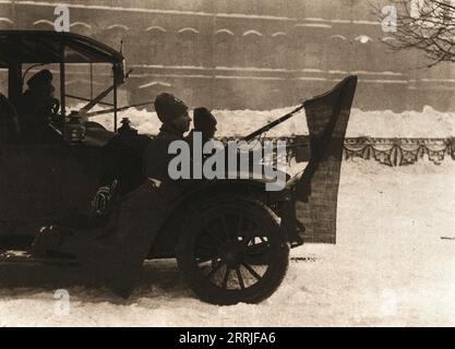 „La Revolution Russe; Pendant les journees sanglantes: Des automobiles remplies de soldats Arm&#xe9;s Battent les rues. Les deux hommes appuy&#xe9;s aux pare-boue de cette voiture ont decor&#xe9; leur baionnette d'une flamme rouge', 1917. Die Russische Revolution: Während der Tage des Blutvergießens patrouillieren Autos voller bewaffneter Soldaten auf den Straßen. Die beiden Männer auf den Schlammschutzvorrichtungen haben rote Fahnen an ihren Bajonetten gehängt. Aus L’Album de la Guerre 1914-1919, Band 2 [L’Illustration, Paris, 1924]. Stockfoto