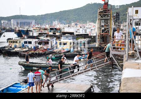 220824 -- YANGJIANG, 24. August 2022 -- Seeleute kehren in einen Hafen zurück, um in der Stadt Yangjiang, Provinz Guangdong in Südchina, am 24. August 2022 Zuflucht zu suchen. Nach Angaben des Ministeriums für natürliche Ressourcen aktivierte China am Mittwoch eine Stufe-IV-Notfallreaktion auf mögliche geologische Katastrophen, die durch den Taifun Ma-on ausgelöst wurden. Taifun Ma-on, der neunte Taifun des Jahres, wird voraussichtlich am Donnerstag tagsüber an der Küste der Provinz Guangdong landen und sintflutartige Regenfälle in die südlichen Teile des Landes bringen. CHINA-GUANGDONG-TYPHOON-MA-ON CN DENGXHUA PUBLICATIONXNOTXINXCHN Stockfoto