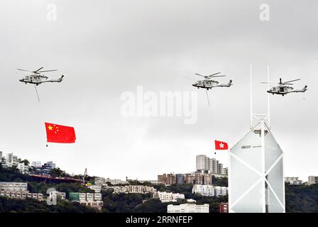 230109 -- PEKING, 9. Januar 2023 -- Chinas Nationalflagge und die Flagge der Sonderverwaltungsregion Hongkong HKSAR werden von Hubschraubern, die über dem Himmel fliegen, in Hongkong, Südchina, 1. Juli 2022, hängen gesehen. Am Goldenen Bauhinia-Platz feiert die HKSAR-Regierung den 25. Jahrestag der Rückkehr Hongkongs in das Mutterland in Hongkong am 1. Juli 2022. XINHUA-BILDER DES JAHRES 2022-CHINA NEWS LOXPINGXFAI PUBLICATIONXNOTXINXCHN Stockfoto