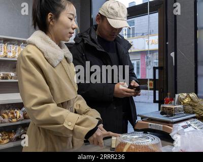 230426 -- TACHENG, 26. April 2023 -- Kunden kaufen Tacheng Käsebrot in einem Geschäft in Tacheng, Nordwestchinas autonome Region Xinjiang Uygur, 1. April 2023. Die kleine Stadt Tacheng liegt an der Grenze von China und Kasachstan und beherbergt Menschen von 25 ethnischen Gruppen. Wang Huipeng und seine Frau eröffneten hier 2016 eine Bäckerei. Jetzt hat sich die Bäckerei zu einer kleinen Lebensmittelfabrik namens Jiangqu mit Mitarbeitern aus 9 verschiedenen ethnischen Gruppen entwickelt. Viele ihrer Produkte sind lokale Favoriten, unter denen ihr charakteristisches Tacheng-Käsebrot immer mehr Aufmerksamkeit erregt und sehr stark geworden ist Stockfoto