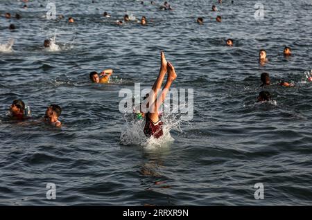 Gaza, Palästina. September 2023. Ein Palästinenser sah, wie er an einem heißen Tag mit steigenden Temperaturen am Seehafen Khan Yunis im südlichen Gazastreifen ins Mittelmeer sprang. (Foto: Yousef Masoud/SOPA Images/SIPA USA) Credit: SIPA USA/Alamy Live News Stockfoto