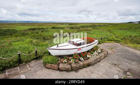 Blick auf ein altes Boot am Ufer von Parkgate hinunter auf die Dee-Mündung in Cheshire, gesehen im September 2023. Stockfoto