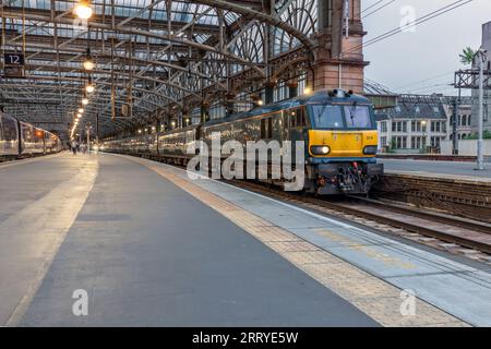 Baureihe 92 Elektrolokomotiv92014 am Bahnhof Glasgow Central mit Kaledonischer Tieflandschlupfbahn, die in der Abenddämmerung auf die Abfahrt wartet Stockfoto