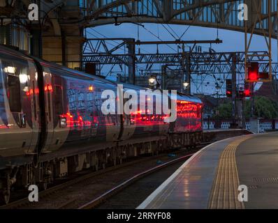 Der Tiefland-Kaledonien-Schlafzug wartet auf die Abfahrt vom Glasgow Central Station mit einem roten Signal, das an der Seite des Zuges glitzert Stockfoto