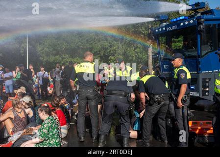 Den Haag, Niederlande. September 2023. Während die Polizei die Wasserkanone einsetzt und der Regenbogen über dem Kopf der Demonstranten erscheint, beginnen die Polizisten während der Demonstration mit der Festnahme. Tausende von Klimaaktivisten der Extinction Rebellion blockierten die Autobahn A12 in den Haag, Niederlande. Sie versuchen, die Regierung unter Druck zu setzen, aufgrund des Klimawandels sofort keine Investitionen in fossile Brennstoffe mehr zu tätigen. (Foto: Krisztian Elek/SOPA Images/SIPA USA) Credit: SIPA USA/Alamy Live News Stockfoto