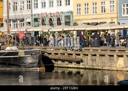 Kopenhagen, Dänemark, 26. Februar 2022: Menschen genießen einen sonnigen Tag in Nyhavn Habor Stockfoto