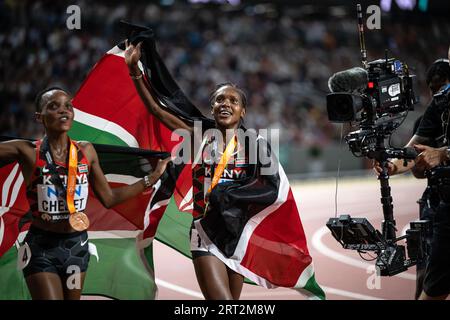 Faith Kipyegon und Beatrice Chebet feiern bei den Leichtathletik-Weltmeisterschaften in Budapest die Hermedal mit der Flagge ihres Landes auf den 5000 Metern Stockfoto