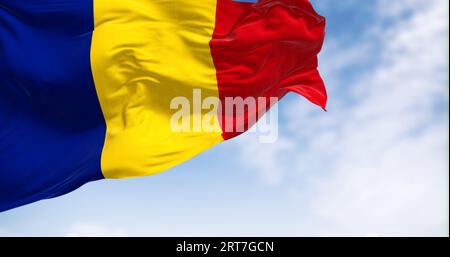 Die rumänische Nationalflagge weht an einem klaren Tag im Wind. Drei vertikale Streifen in Blau, Gelb und Rot. 3D-Illustrations-Rendering. Flatterndes Material. Stockfoto