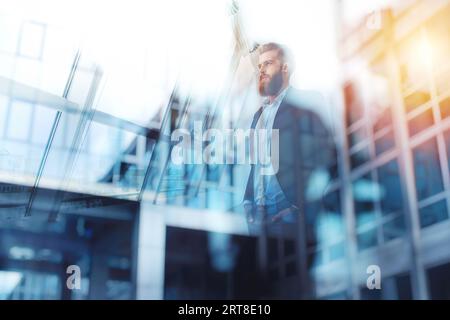 Rücksichtsvoller Hipster-Geschäftsmann im Büro. Doppelbelichtungseffekte Stockfoto