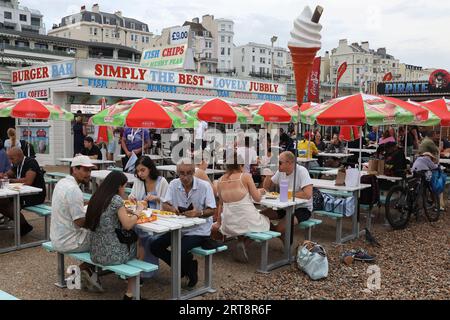 Gruppen von Menschen essen Essen in einem Fish and Chip Restaurant am Brighton Seafront Stockfoto