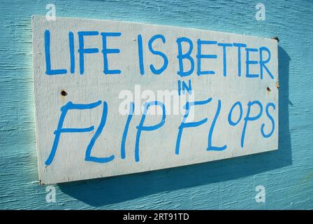 Das Leben ist besser in Flip Flops Sign, Strandhütten, Small Hope Beach, Shanklin, Isle of Wight, Hampshire, England. Stockfoto