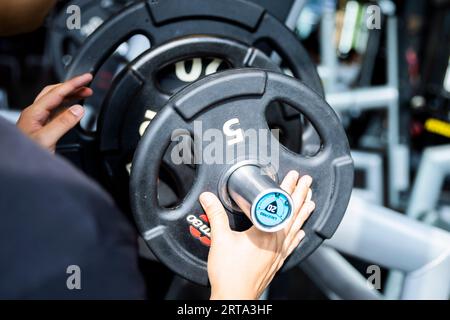 Berlin, Deutschland. 04. Juli 2023. Ein amerikanischer Fußballspieler passt das Gewicht für Squats in einem Fitnessstudio in Berlin-Wedding an. Kredit: Christoph Soeder/dpa/Alamy Live News Stockfoto