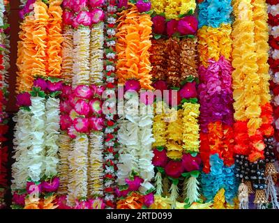 Mehrfarbige künstliche Blumen, die für die Dekoration des Diwali-Festivals verwendet werden und in einem Geschäft am Tag vor dem Diwali- und Ganesh-Festival hängen Stockfoto