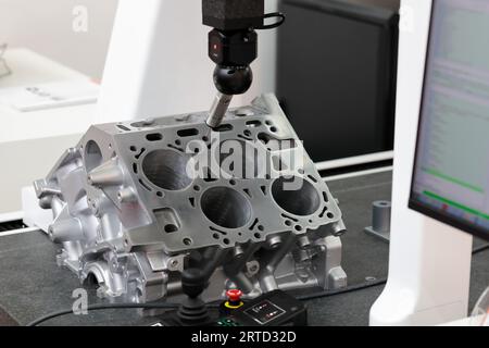 Dimensionsprüfung durch automatische CMM-Maschine. Brückenkoordinatenmessgerät zur Inspektion von Kfz-Motorteilen. Selektiver Fokus. Stockfoto