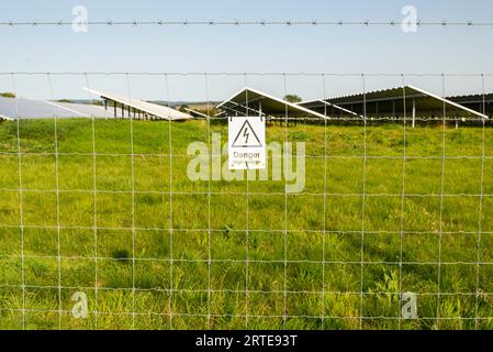 Am Stacheldraht-Sicherheitszaun befestigt, um einen Bereich von Solarzellen herum, an einem abgelegenen ländlichen Ort in der Cotswolds-Gegend der englischen Countrys Stockfoto
