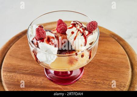 Pfirsiche mit Himbeeren, Vanilleeis, Fruchtmarmelade und Mandeln Stockfoto