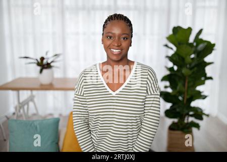 Porträt einer heiteren afrikanerin, die zu Hause posiert Stockfoto